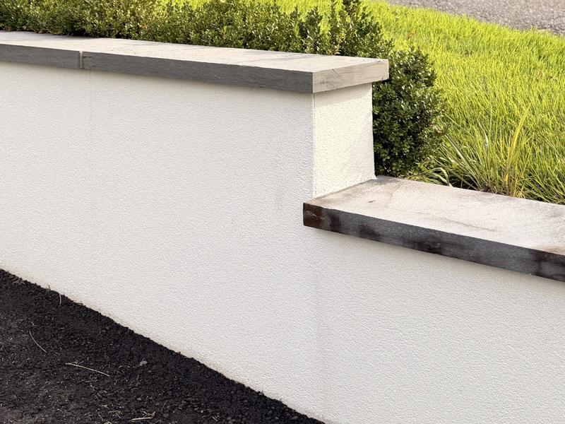 After: the same retaining wall with the rust drip removed